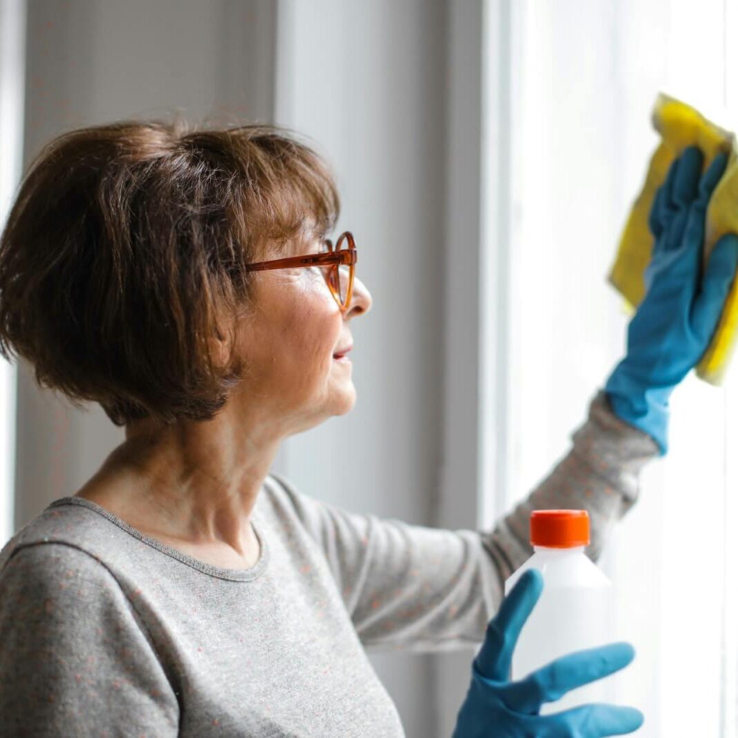 residential-cleaning-woman-cleaning-window-spring-cleaning